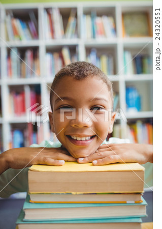 Boy putting his head on books Boy putting his head on books 24320551