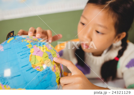 Girl studying the globe 24321129