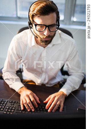 Businessman with glasses working on computer Businessman with glasses working on computer 24321793