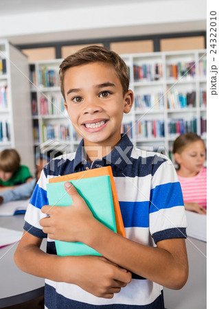 Little boy standing with notebooks Little boy standing with notebooks 24322010