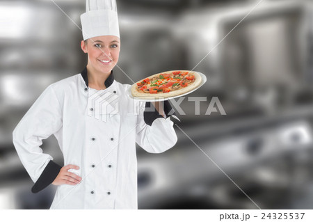 Composite image of confident female chef holding pizza 24325537
