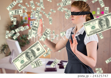 Composite image of redhead businesswoman in a blindfold 24325747