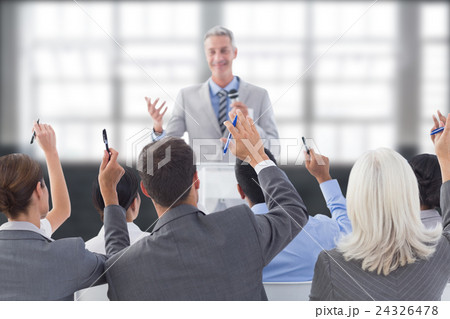 Composite image of business people raising their arms during meeting Composite image of business people raising their arms during meeting 24326478
