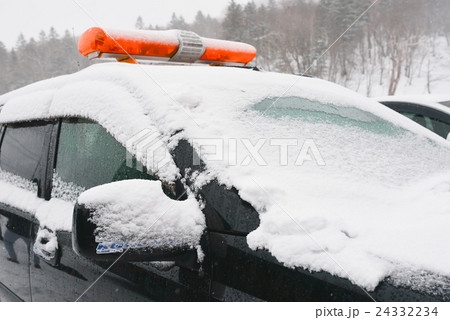 snow fall on the front of police car snow fall on the front of police car 24332234