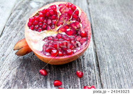 Juicy pomegranates on wood Juicy pomegranates on wood 24343025
