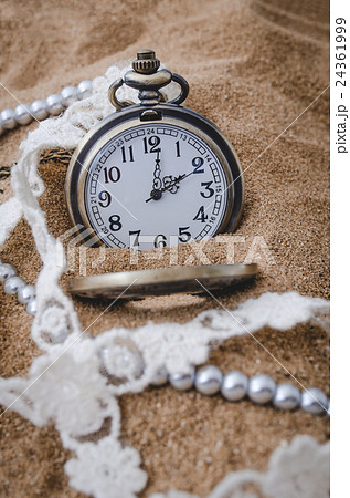 Vintage pocket watch on sand background Vintage pocket watch on sand background 24361999