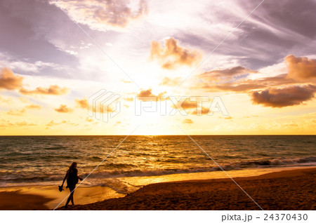 silhouette woman walking on the beach 24370430