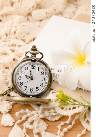Vintage pocket watch with blank note book on lace Vintage pocket watch with blank note book on lace 24370480