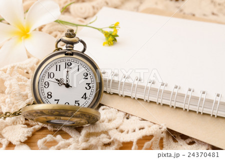 Vintage pocket watch with blank note book on lace Vintage pocket watch with blank note book on lace 24370481