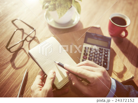 Hands of Businessman Working with Calculator 24372152