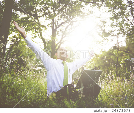 Businessman Sitting In a Forest With His Laptop 24373673