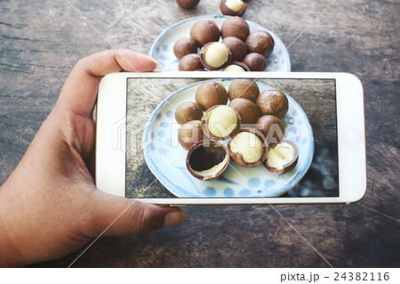 Taking a photo of macadamia nuts with smart phone 24382116
