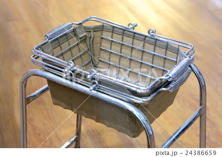 Metallic basket on shelf in supermarket Metallic basket on shelf in supermarket 24386659