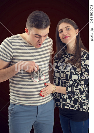 Young couple announcing their baby isolated Young couple announcing their baby isolated 24390978