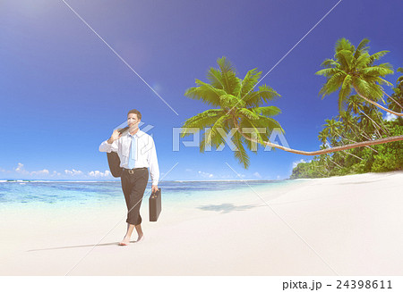 Businessman Walking Along the Tropical Beach 24398611