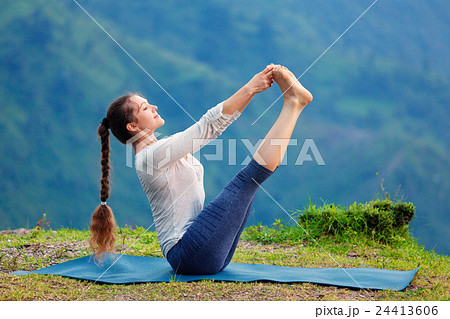 Woman doing Ashtanga Vinyasa Yoga asana outdoors Woman doing Ashtanga Vinyasa Yoga asana outdoors 24413606