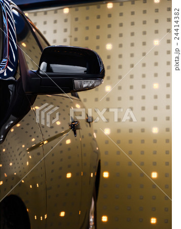 Black car side against light wall background 24414382