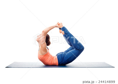 Sporty fit woman practices yoga asana Dhanurasana Sporty fit woman practices yoga asana Dhanurasana 24414899