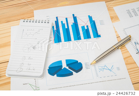 Financial charts on the table . 24426732