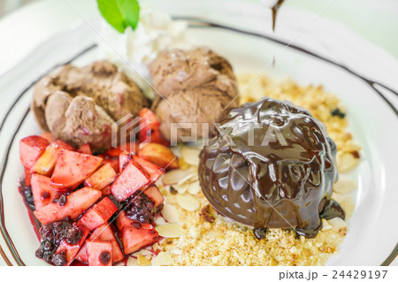 Chocolate cake with fruit peach, black currant, blueberry, apple, ice cream Chocolate cake with fruit peach, black currant, blueberry, apple, ice cream 24429197