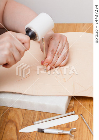 craftsman puts picture on leather 24437294