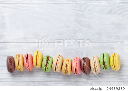Colorful macaroons on wooden table 24439880