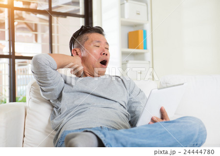 asian male with neck pain when using too much gadgets asian male with neck pain when using too much gadgets 24444780
