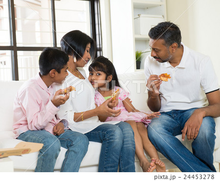 happy indian family eating pizza at home 24453278