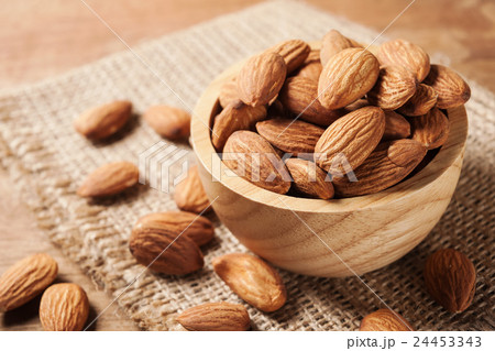 Almond snack fruit in wooden bowl Almond snack fruit in wooden bowl 24453343