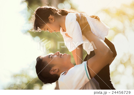 Father carrying daughter Up looking happily, 24456729