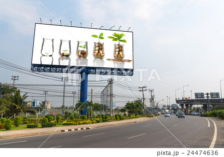 Billboard showing the Gold coins and seed in clear bottle on white background,Business investment growth concept 24474636
