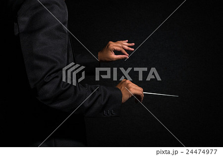 Orchestra conductor hands, Musician director holding stick on dark background 24474977