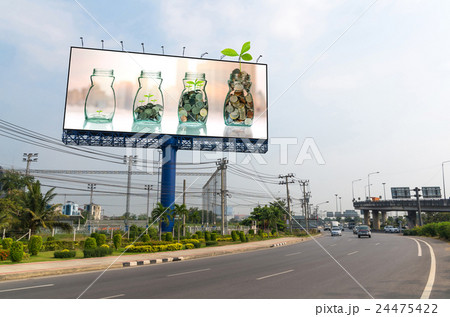 Billboard showing the mix coins and seed in clear bottle on on cityscape photo blurred cityscape background for advertisement, Business investment growth concept 24475422