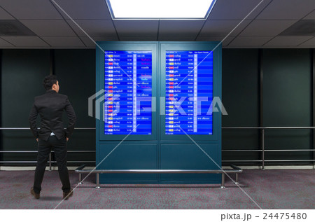 Back side of Businessman looking airplanes schedule flight board, Business travel concept 24475480