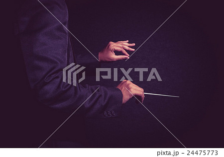 Orchestra conductor hands, Musician director holding stick on dark background Orchestra conductor hands, Musician director holding stick on dark background 24475773