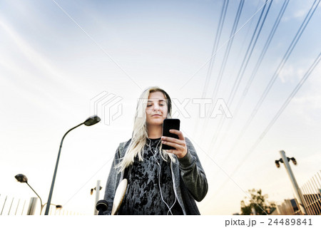 Young Woman Skater Browsing Phone Concept 24489841