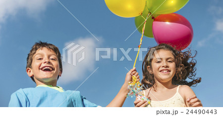 Happy Boy Girl Dozen Helium Balloons Playful Concept 24490443