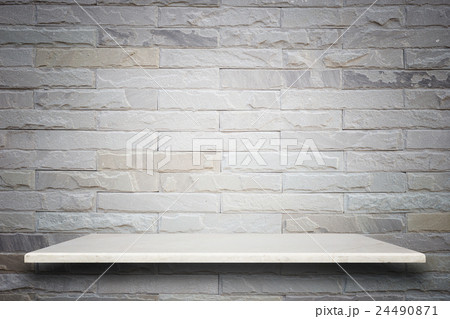 Empty top of natural stone shelves and stone wall background 24490871