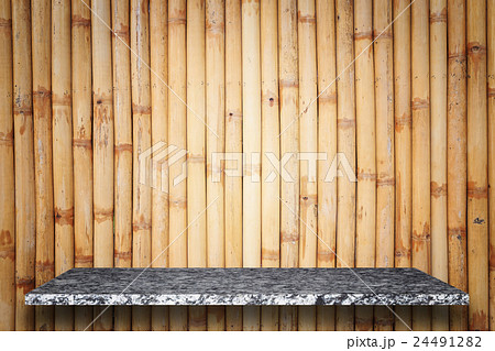 Empty top of natural stone shelves and bamboo wall background 24491282