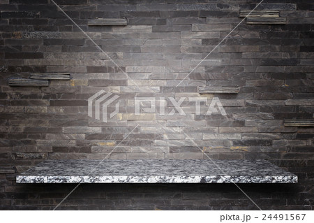 Empty top of natural stone shelves and stone wall background 24491567