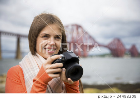 Photographer shooting landscape photos with of The Forth Bridge. 24493209