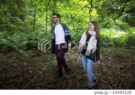 Relaxed couple hugging while walking outdoors. 24493226