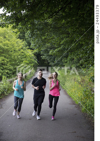 Athletic Caucasian friends running outdoors. 24493379