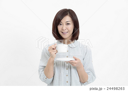 ティーカップを持つ中年女性の写真素材