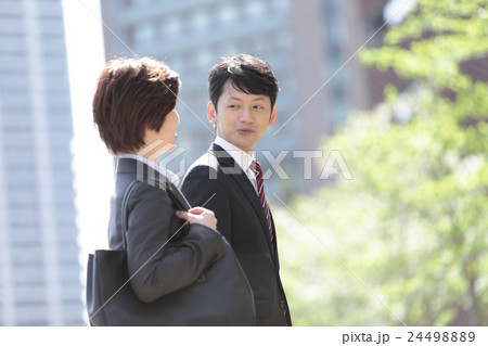 会話するビジネスマンとビジネスウーマン 会話するビジネスマンとビジネスウーマン 24498889