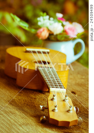 Ukulele over old wood in vintage style, Ukulele over old wood in vintage style, 24509499