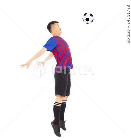 Young soccer player jumping to stop ball by chest 24511723
