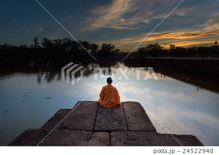 monk sit on the shore at angor wat ,cambodia . 24522948