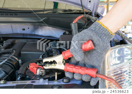 automotive technician charging vehicle battery automotive technician charging vehicle battery 24536623
