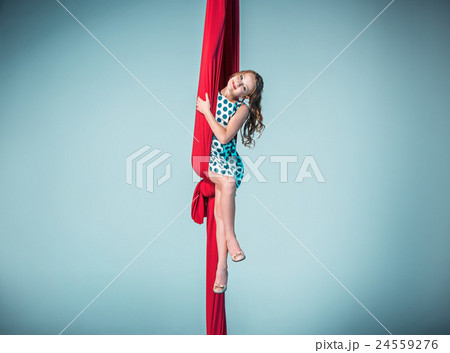 Graceful gymnast sitting with red fabrics 24559276